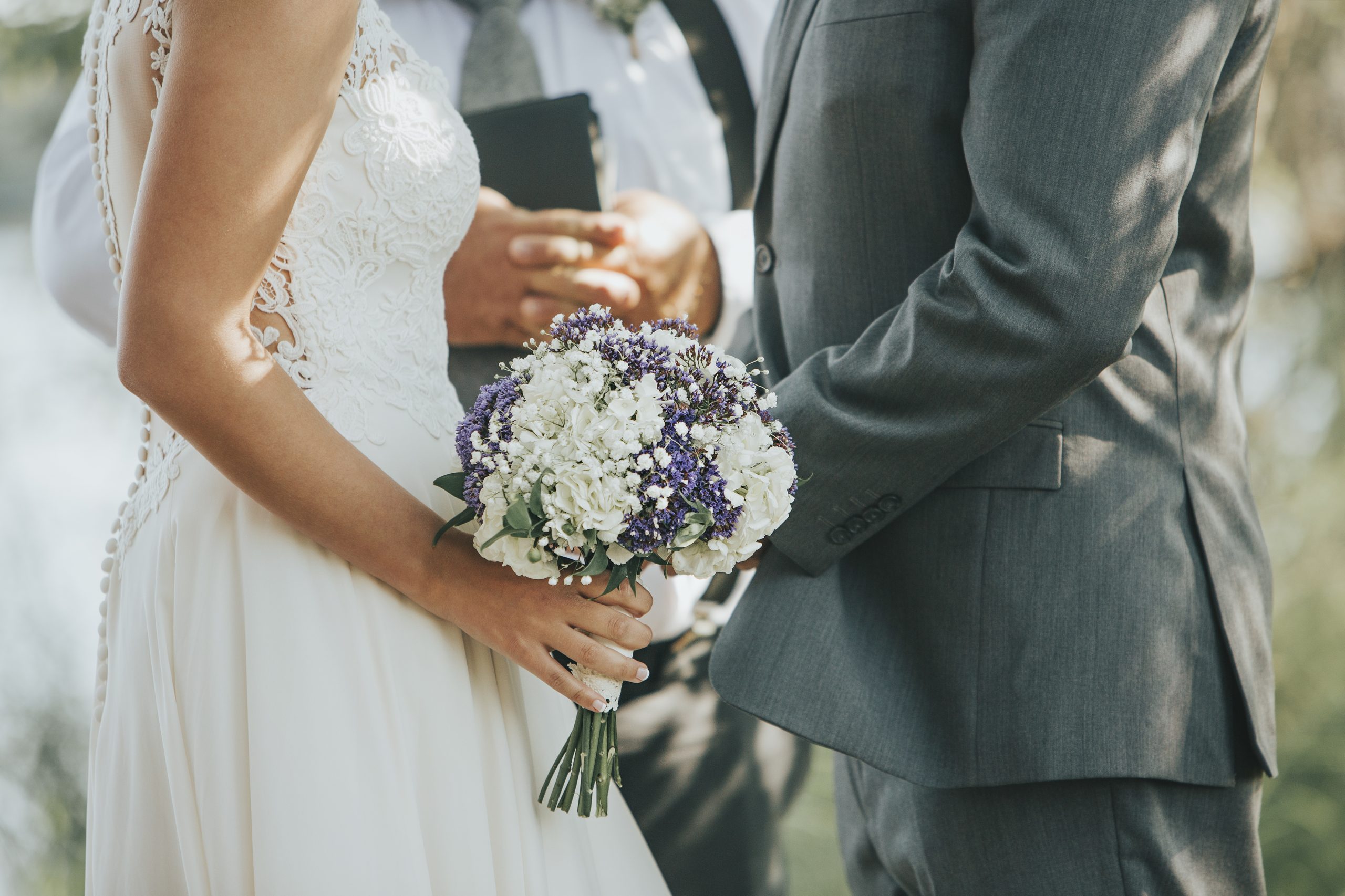 Wedding couple holding hands giving vows